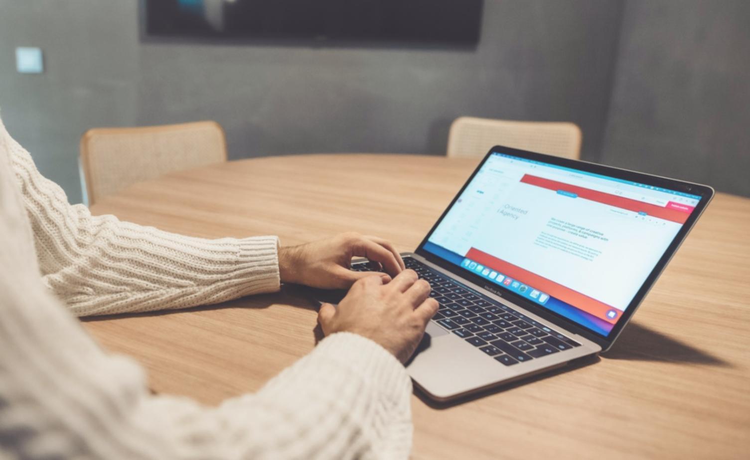 Designer reviewing mobile app interface layouts on tablet
